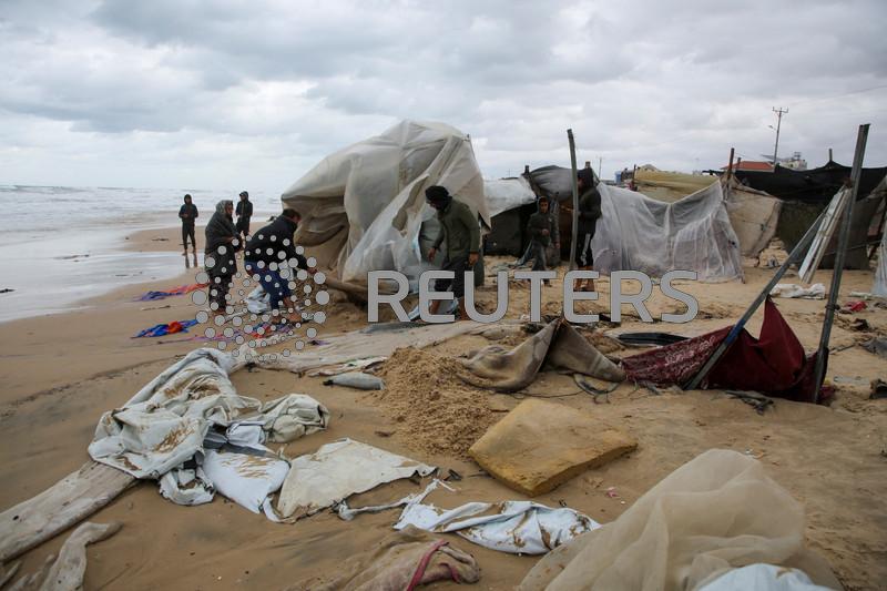 Rainstorms flood tents of Gaza's displaced as Israel steps up strikes