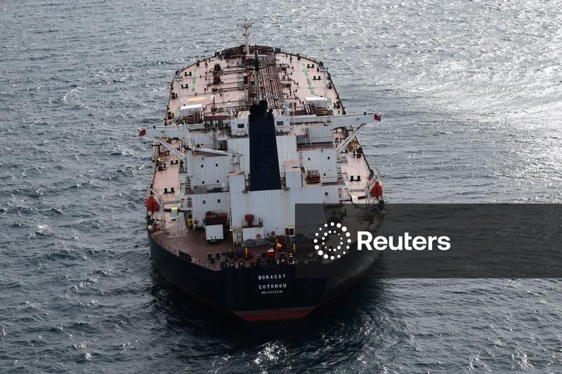 Oil slips on oversupply worries, sanctions risk in focus