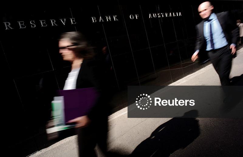 Australia's central bank holds rates steady, signals no rush to hike