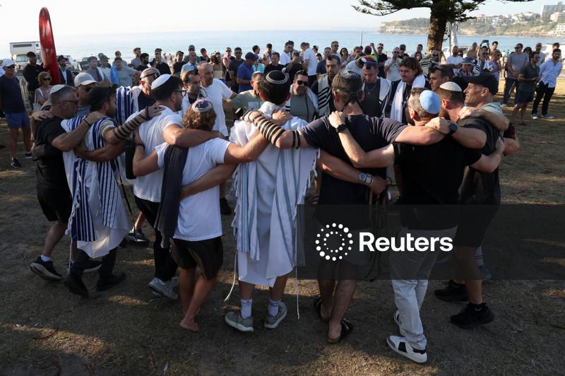 Australia plans gun buyback after Bondi massacre, as surfers honour victims