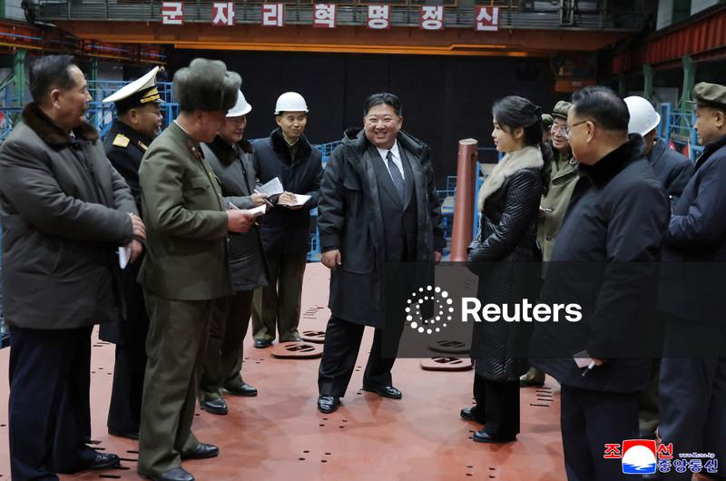 North Korea's Kim Jong Un views submarine construction, oversees missile launch, KCNA says