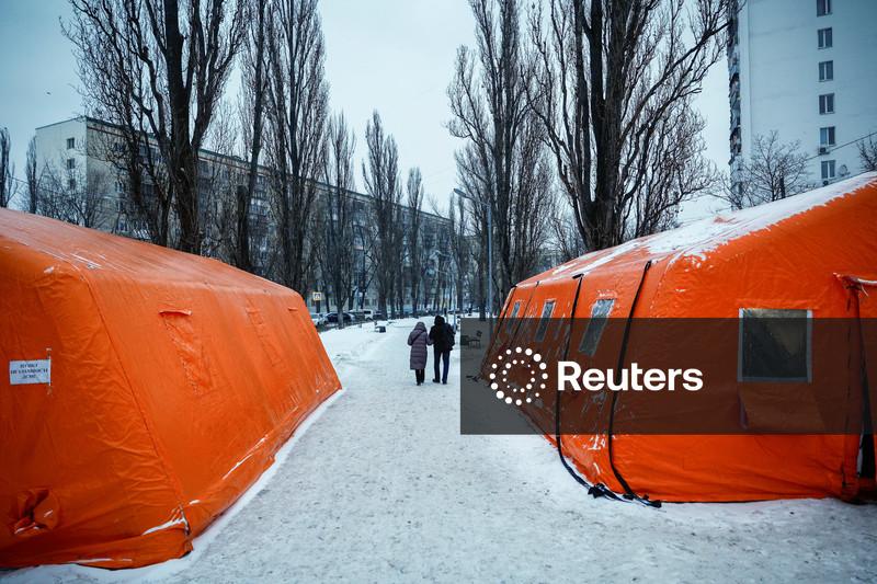 Ukraine's two largest cities under Russian attack, officials say one dead