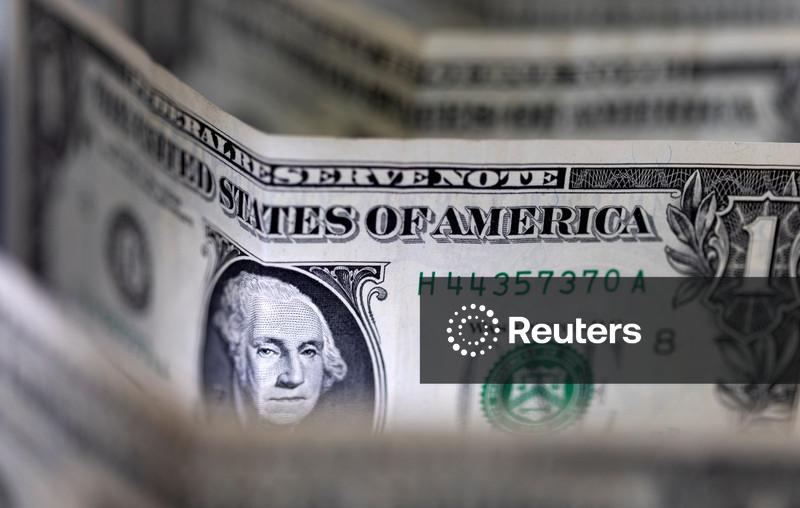 Dollar sinks to four-year low, Trump brushes off the decline