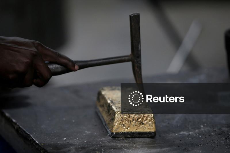 Factbox-UBS raises gold price target to $6,200/oz